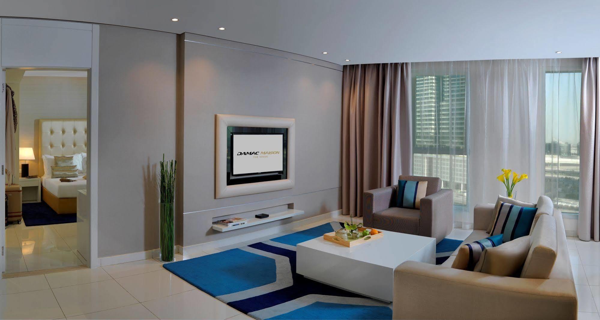 Damac Maison The Vogue Dubai Exterior photo A living room with a television